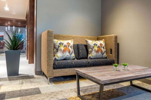 a living room with a couch and a table at Cambria Hotel Milwaukee Downtown in Milwaukee