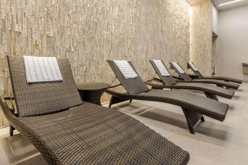 a row of chairs sitting in a row in a room at Cambria Hotel Milwaukee Downtown in Milwaukee