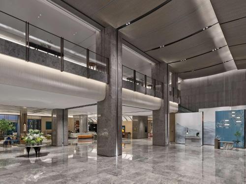 a lobby of a building with columns and a table at Doubletree By Hilton Chengdu Xinglong Lake in Chengdu