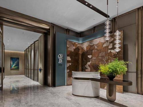 a hallway with a lobby with a wall at Doubletree By Hilton Chengdu Xinglong Lake in Chengdu