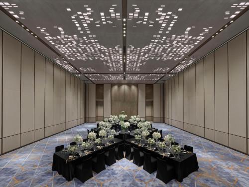 a room with a long table with flowers on it at Doubletree By Hilton Chengdu Xinglong Lake in Chengdu