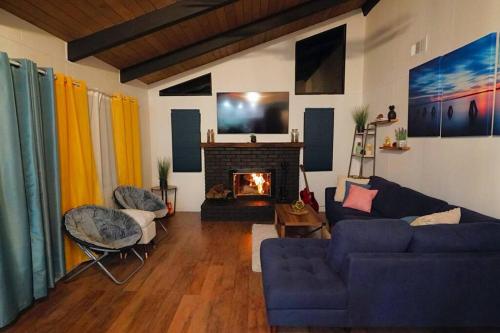 a living room with a couch and a fireplace at Beautiful Renovated Cozy Forest Home with Hot Tub in Crestline in Crestline