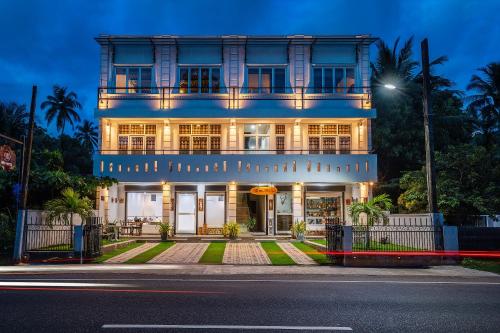 a large blue building with a street in front of it at Hiru Hotel in Beruwala