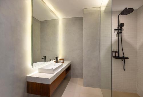 a bathroom with a sink and a mirror at Dialoog Seminyak in Seminyak