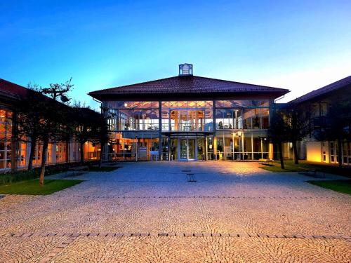 a large building with a lot of windows at Sportschule Oberhaching in Oberhaching