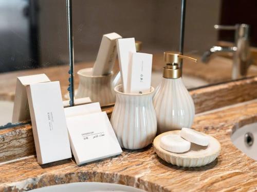 a bathroom counter with a sink and a mirror at Royal Vista at Burj Views - Dubai City & Burj Khalifa Views - Brand New Luxury 2BR Apartment in Dubai