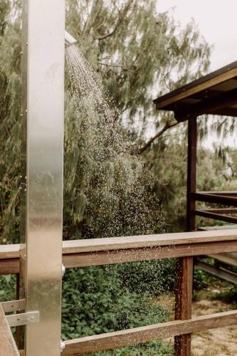 a spray of water on top of a fence at Azzure Bliss at Bokarina Beach in Kawana Waters