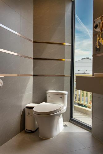a bathroom with a toilet and a balcony at Phuc Hai Hotel Da Lat in Da Lat