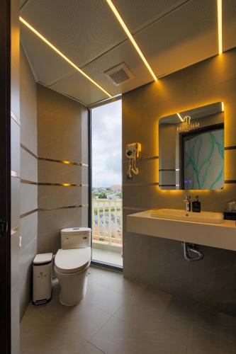 a bathroom with a toilet and a sink and a window at Phuc Hai Hotel Da Lat in Da Lat