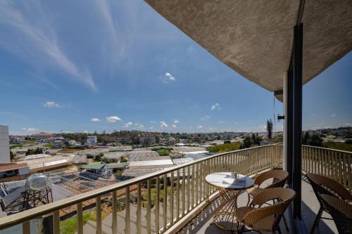 a balcony with chairs and a table and a view at Phuc Hai Hotel Da Lat in Da Lat
