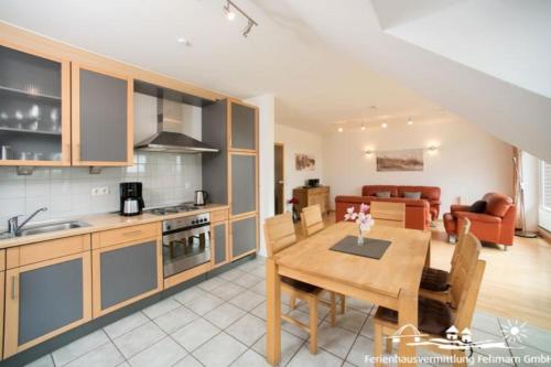 a kitchen and living room with a table and a dining room at 53 Ferienwohnung im Fritz-Bleyl-Weg 14 OG rechts in Burg auf Fehmarn