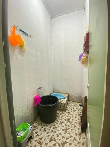 a small bathroom with a tub and a toilet at Embun Padi Homestay in Karawang