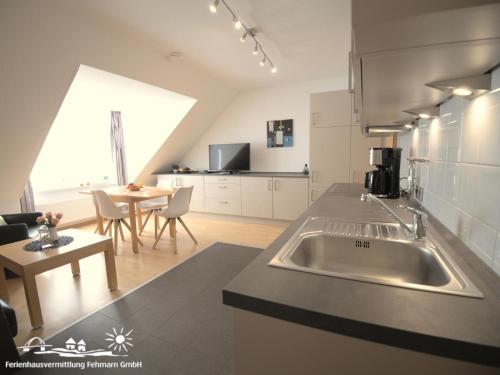 a kitchen with a sink and a living room at 56 Ferienwohnung im Fritz-Bleyl-Weg 14 DG links in Burg auf Fehmarn
