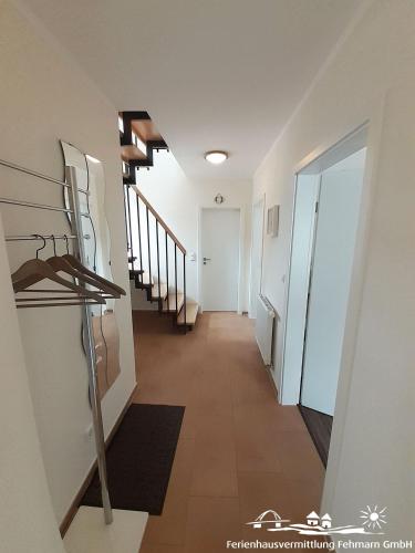 a hallway of a building with stairs and a hallway at 44 Apartment Sunshine Birkenweg 1c OG in Burg auf Fehmarn