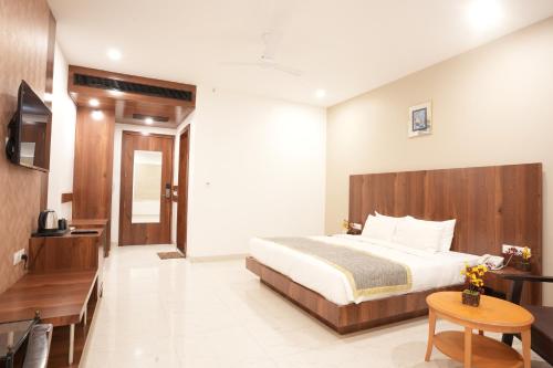 a hotel room with a bed and a television at Stamps by Eight Continents, Jodhpur in Jodhpur