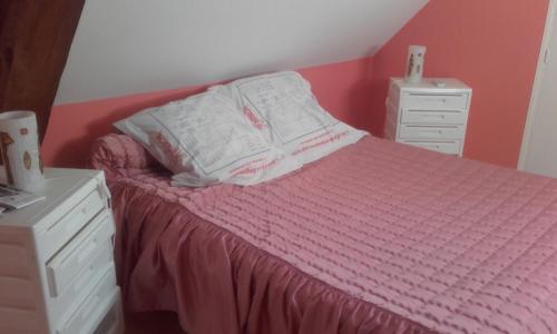 a bedroom with a bed with a newspaper on it at Les chambres de la Bosse in La Bosse