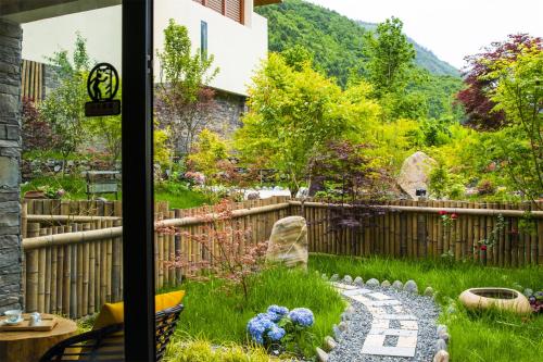 a garden view from the window of a house at Summergarden Hotel in Wolongguan