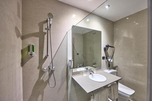 a bathroom with a shower and a sink and a toilet at Civis Jaime I in Castellón de la Plana