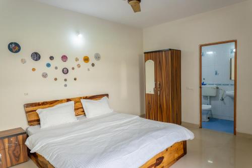 a bedroom with a large bed and a bathroom at 2BHK Private Apartment with Pool access in Varca