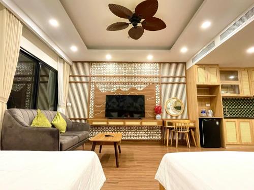 a living room with a couch and a fireplace at Tony Apartment -FLC Sea Tower Quy Nhon in Quy Nhon