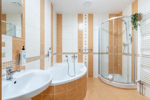 a bathroom with a sink and a shower at Penzion Mountain in Čeladná