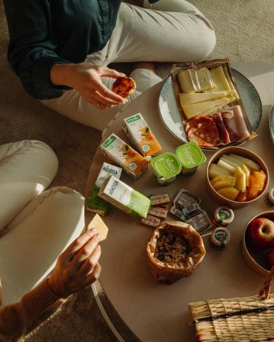a group of people sitting around a table with food at Dom Pedro Residences in Vilamoura