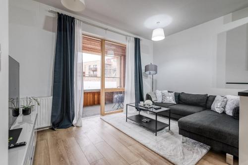 a living room with a couch and a table at Canning Town Pied-à-Terre in London