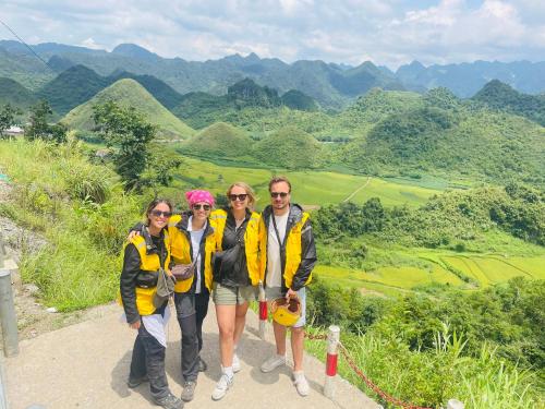 a group of people standing on top of a mountain at Strawberry House , Tour & Motorbikes Rentel in Ha Giang