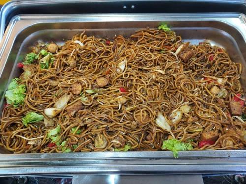 a tray filled with noodles and other foods at Hotel Seri Malaysia Pulau Pinang in Bayan Lepas