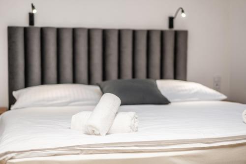 a bed with two rolled up towels on it at Penzion Mountain in Čeladná