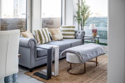 a living room with a couch and a table at Canary Wharf Retreat with Free Secure Parking in London