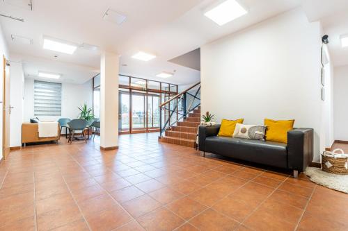 an office lobby with a couch and a staircase at Penzion Mountain in Čeladná