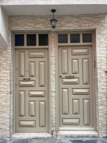 a pair of garage doors on a building at Appart Ayoub in Essaouira