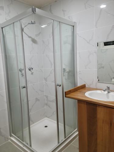 a bathroom with a shower and a sink at Seghe Accommodation in Seghe