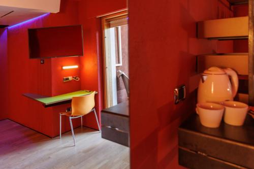 a red room with a desk and a chair at Ambienthotel PrimaLuna 3S in Malcesine
