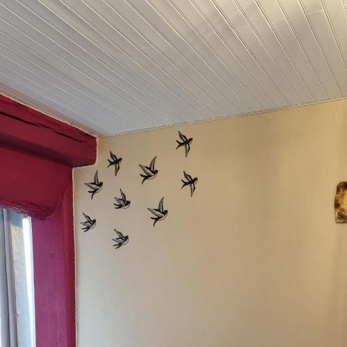 a flock of birds on the wall of a room at L'hirondelle in Le Grand Serre
