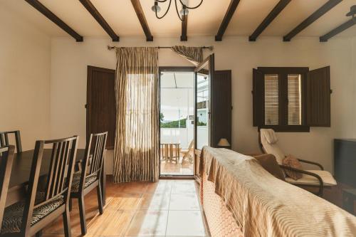 a living room with a couch and a table and chairs at Casa Higuera de la Sierra in Higuera de la Sierra