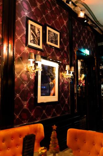 a room with a couch and pictures on a wall at The Pavilions Amsterdam, The Toren in Amsterdam