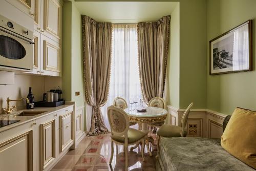 a kitchen with a table and chairs in a room at Maison des Barons in Nice