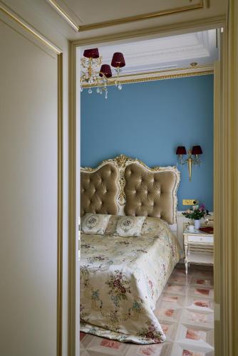 a bedroom with a bed with a blue wall at Maison des Barons in Nice