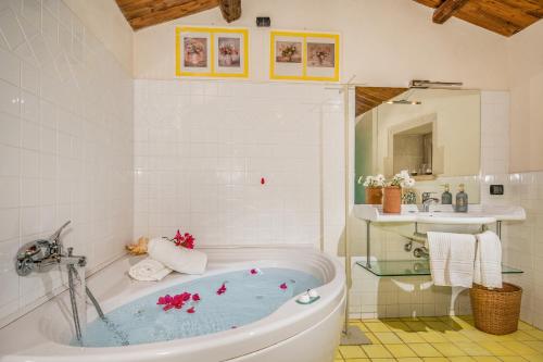 a bathroom with a tub and a sink at VILLA RAMUNNA 6, Emma Villas in Rosolini