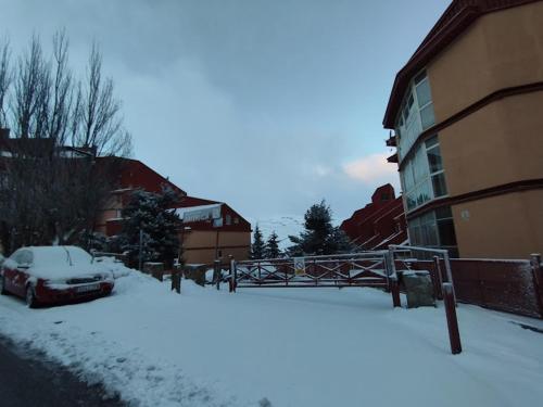 a car parked in the snow next to a building at Sierra Nevada in Sierra Nevada