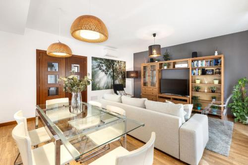 a living room with a white couch and a glass table at Aquavilla in Costa Teguise