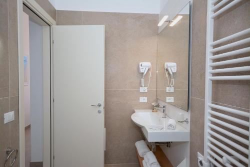 a bathroom with a sink and a mirror at Hotel Miramare in Otranto