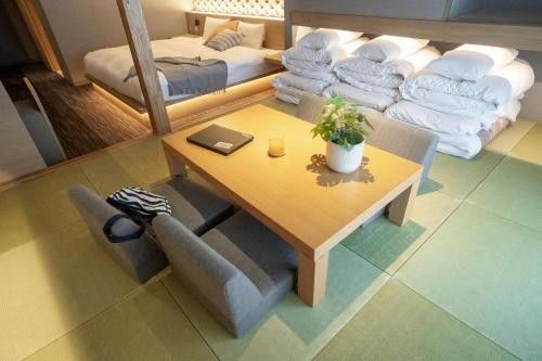 a living room with a table and a couch at ORI Kyoto in Kyoto