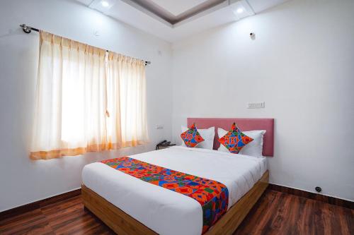 a bedroom with a large bed in a room at FabHotel HSR Gateway in Bengaluru