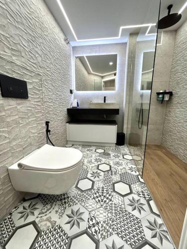 a bathroom with a white toilet and a shower at La Catedral - Más que apartamentos lujo in Murcia