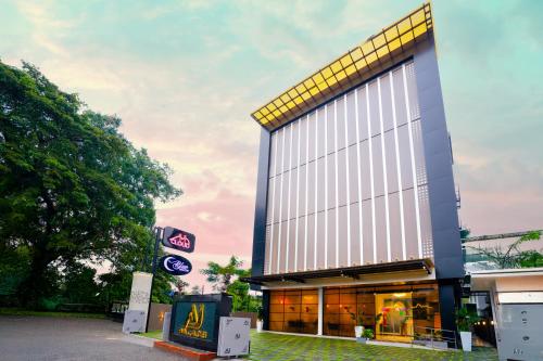 a store front of a building with a sign in front at AJ Palace in Alleppey
