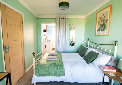 a bedroom with a white bed and a table at Broadstairs, Bays & Golf - Sleeps 2 in Broadstairs