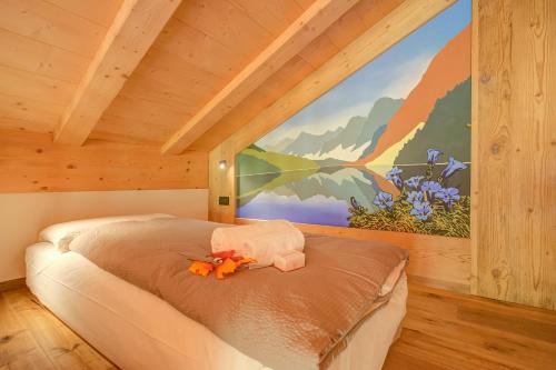 a bed in a room with a painting on the wall at Cuore Alpino in Livigno
